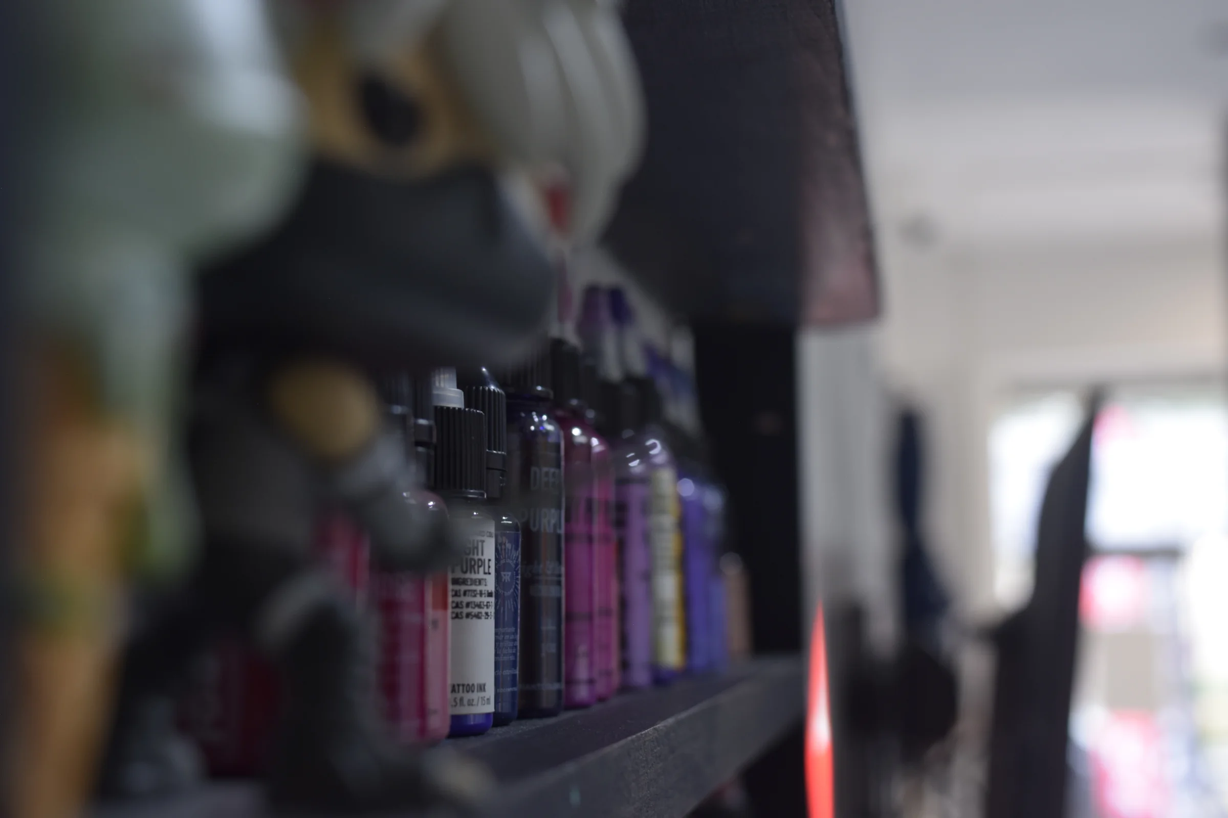 Professional tattoo artist carefully working on detailed artwork